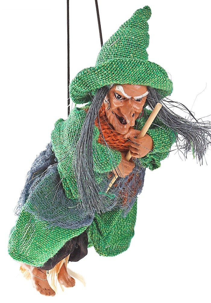 Баба яга в одежде - лохмотьях, с метлой, висит